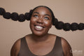 Studio shot of smiling young woman with braided hair