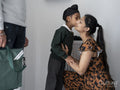 Boy kissing mother on cheek before going to school