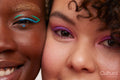 Portrait of two young women wearing make up, cheek to cheek