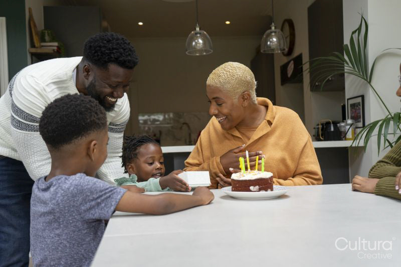 Family with children celebrating birthday at home