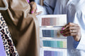 Close-up of fashion designer comparing color swatches with clothing