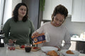 Two women preparing breakfast in kitchen