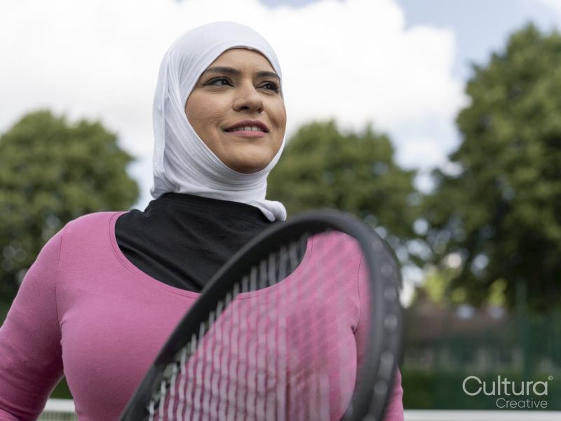 Sutton,Portrait of smiling woman in headscarf at tennis court