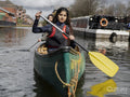 Two young women canoeing in canal