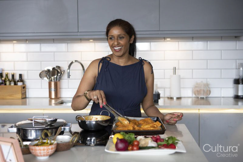 Smiling woman cooking in kitchen