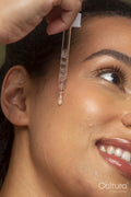 Close-up of woman dropping face oil on face
