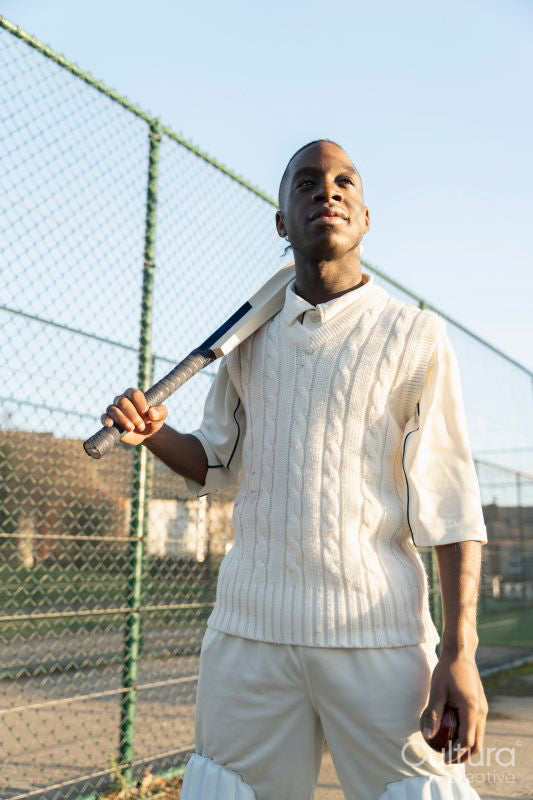 Portrait of cricketer standing on outdoors sports court