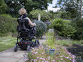 Woman in electric wheelchair outdoors