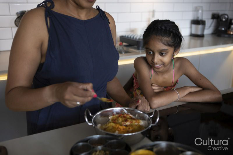 Mother and daughter cooking in kitchen