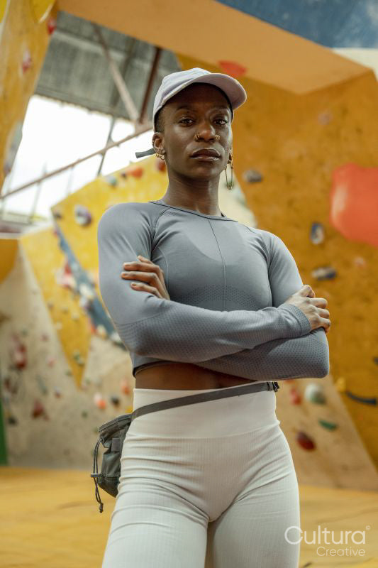 Portrait of woman in front of climbing wall
