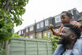 Father giving daughter piggyback ride