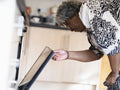 Mature woman opening oven door