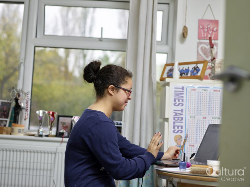 Girl with Down syndrome using laptop