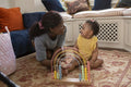 Mother playing with baby daughter at home