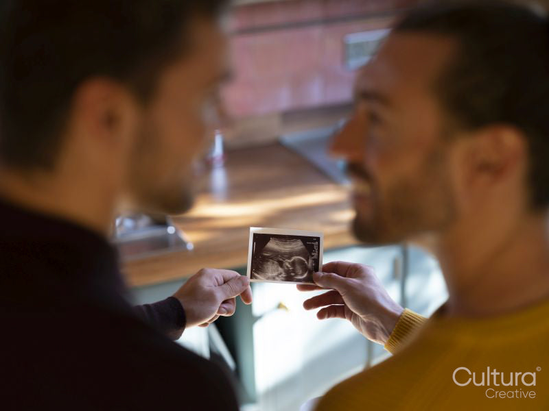 couple holding baby ultrasound scan
