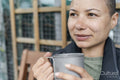 Close-up of woman holding metal mug in urban garden