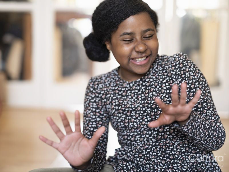 Smiling girl looking at fingernails