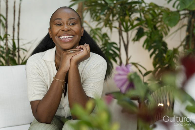 Happy woman sitting in office lounge