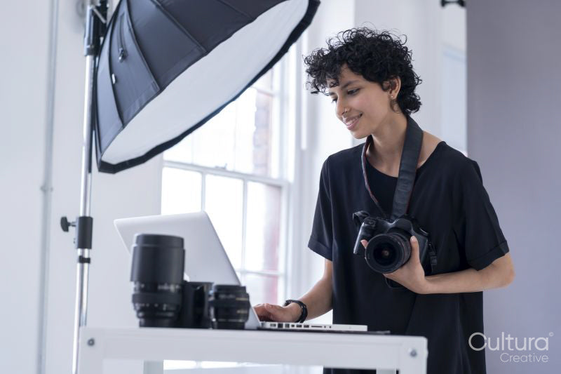 Female photographer using laptop
