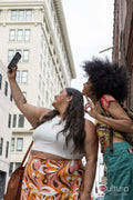 Two women taking selfie in street
