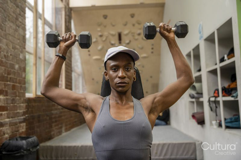 Woman exercising with dumbbells at gym