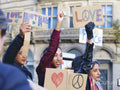 Activists holding peace signs protesting in street