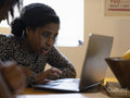 Girl using laptop at home
