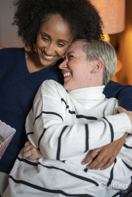 Smiling couple embracing at home