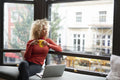 Woman looking through office window