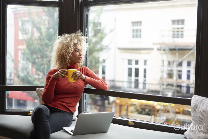 Woman looking through office window