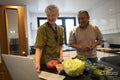 Smiling senior couple looking at laptop in kitchen