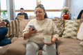 Senior woman using smart phone in living room