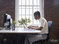 Teenage boy using laptop in office