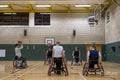 Man in wheelchair doing free throw during match