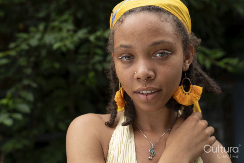 Portrait of young woman looking at camera in garden