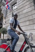 Mature man using city bike on street