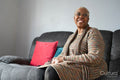 Mature woman sitting in living room