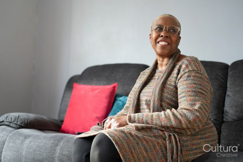 Mature woman sitting in living room