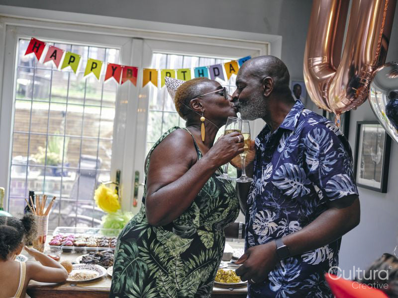 Mature couple kissing at birthday party