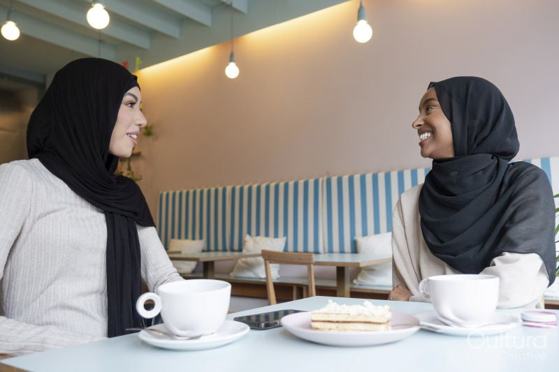 Young female friends meeting in cafe