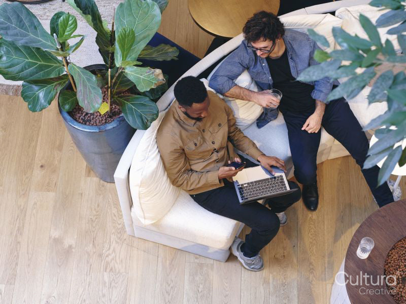 Overhead view of coworkers relaxing in office lobby