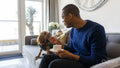 Man with dog sitting on sofa
