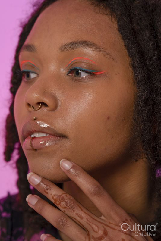 Young woman wearing pink eyeliner and piercings