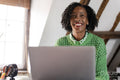 Smiling businesswoman working on laptop in office