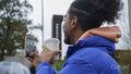 Young man holding phone and coffee