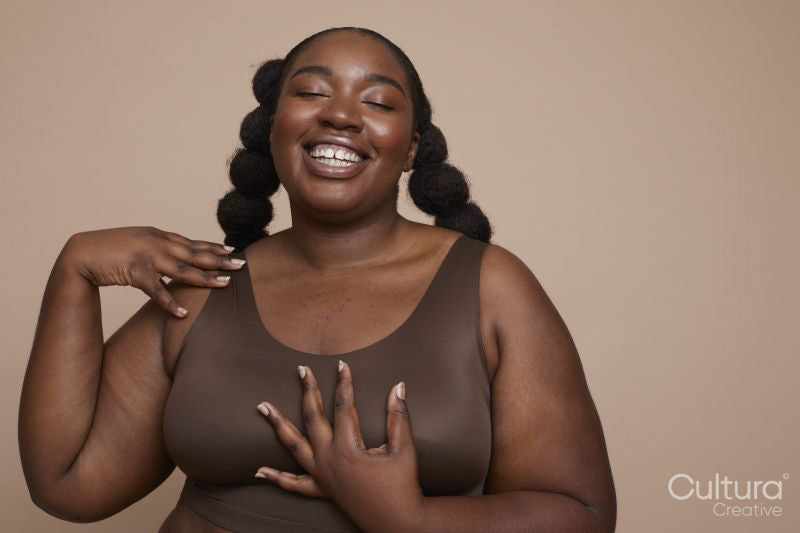 Studio shot of smiling young woman with braided hair