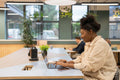 Businesswoman working on laptop in modern office