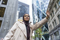 Woman wearing hijab hailing taxi