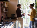 couple standing by window in kitchen