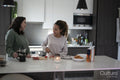 Two women preparing meal in kitchen